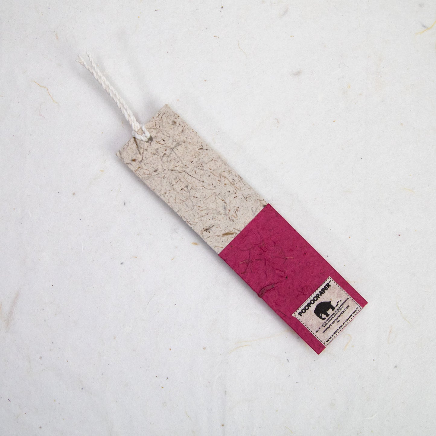 red paper bookmark with poopoopaper label
