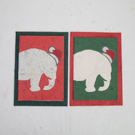 eco-friendly holiday cards in green and red featuring an elephant wearing a santa claus hat